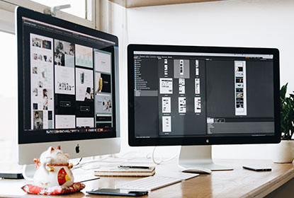 video production company dubai two computers side by side